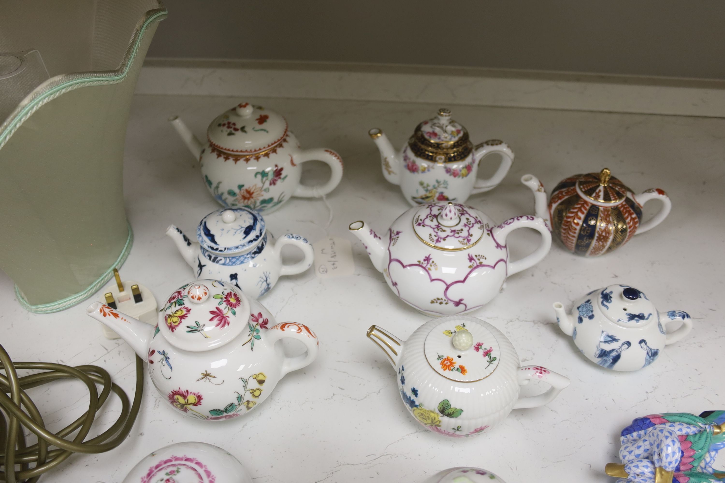 Twelve modern floral-decorated collectors' teapots (V&A Museum Collection), a Spode dish, a table lamp and a Herend duck group (15)